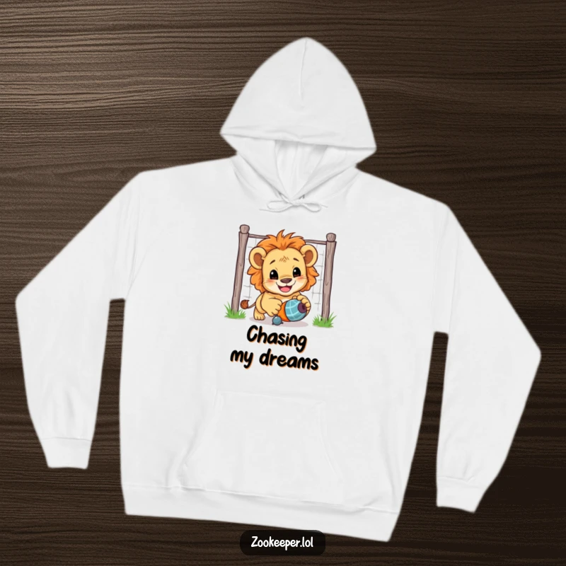 Funny Lion Cub Hoodie: A happy lion cub excitedly chases a toy toy, showcasing its playful and adventurous spirit.