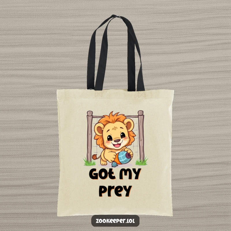 Funny Lion Cub Tote Bag: A smiling lion cub playfully chases a toy toy, adding a touch of wild fun to your day.
